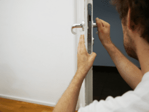 a person holding a door lever